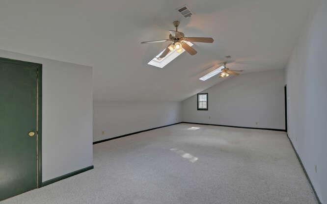 390 Colony Cove Alpharetta, GA 30022 - Photo 21 of 41 en empty room with windows and ceiling fan