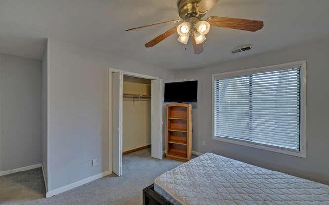 390 Colony Cove Alpharetta, GA 30022 - Photo 22 of 41 a bedroom with a bed and a ceiling fan