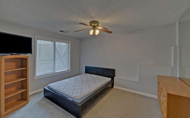 390 Colony Cove Alpharetta, GA 30022 - Photo 23 of 41 a bedroom with a bed and a flat tv screen on the dresser
