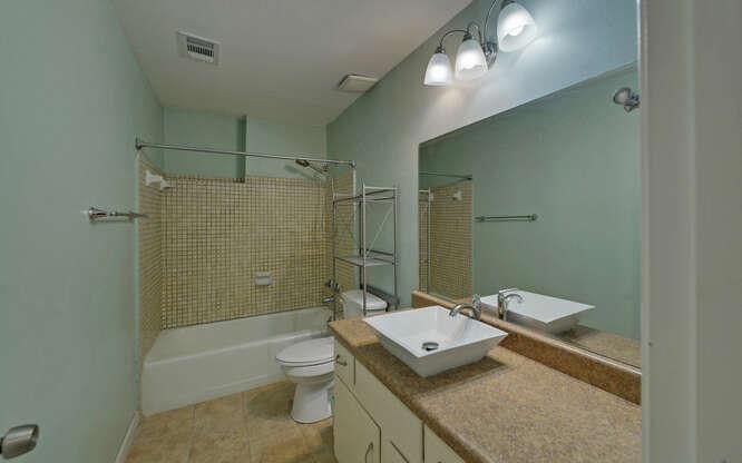 390 Colony Cove Alpharetta, GA 30022 - Photo 25 of 41 a bathroom with a granite countertop sink a toilet and shower