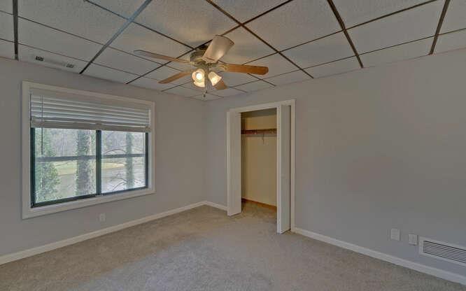390 Colony Cove Alpharetta, GA 30022 - Photo 26 of 41 an empty room with windows and chandelier fan