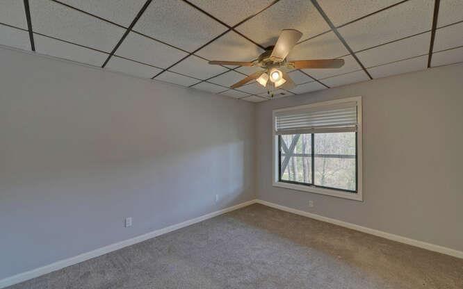 390 Colony Cove Alpharetta, GA 30022 - Photo 28 of 41 an empty room with a chandelier fan and windows