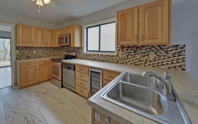 390 Colony Cove Alpharetta, GA 30022 - Photo 3 of 41 a kitchen with a sink cabinets and stainless steel appliances