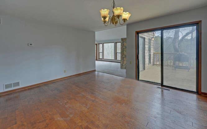 390 Colony Cove Alpharetta, GA 30022 - Photo 9 of 41 an empty room with wooden floor and windows