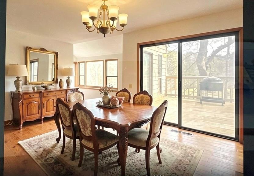 390 Colony Cove Alpharetta, GA 30022 - Photo 10 of 41 a view of a dining room with furniture a chandelier and wooden floor