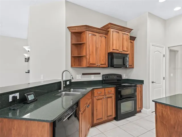 a kitchen with stainless steel appliances granite countertop a sink and stove top oven