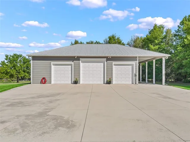 a view of an house with backyard and a garden