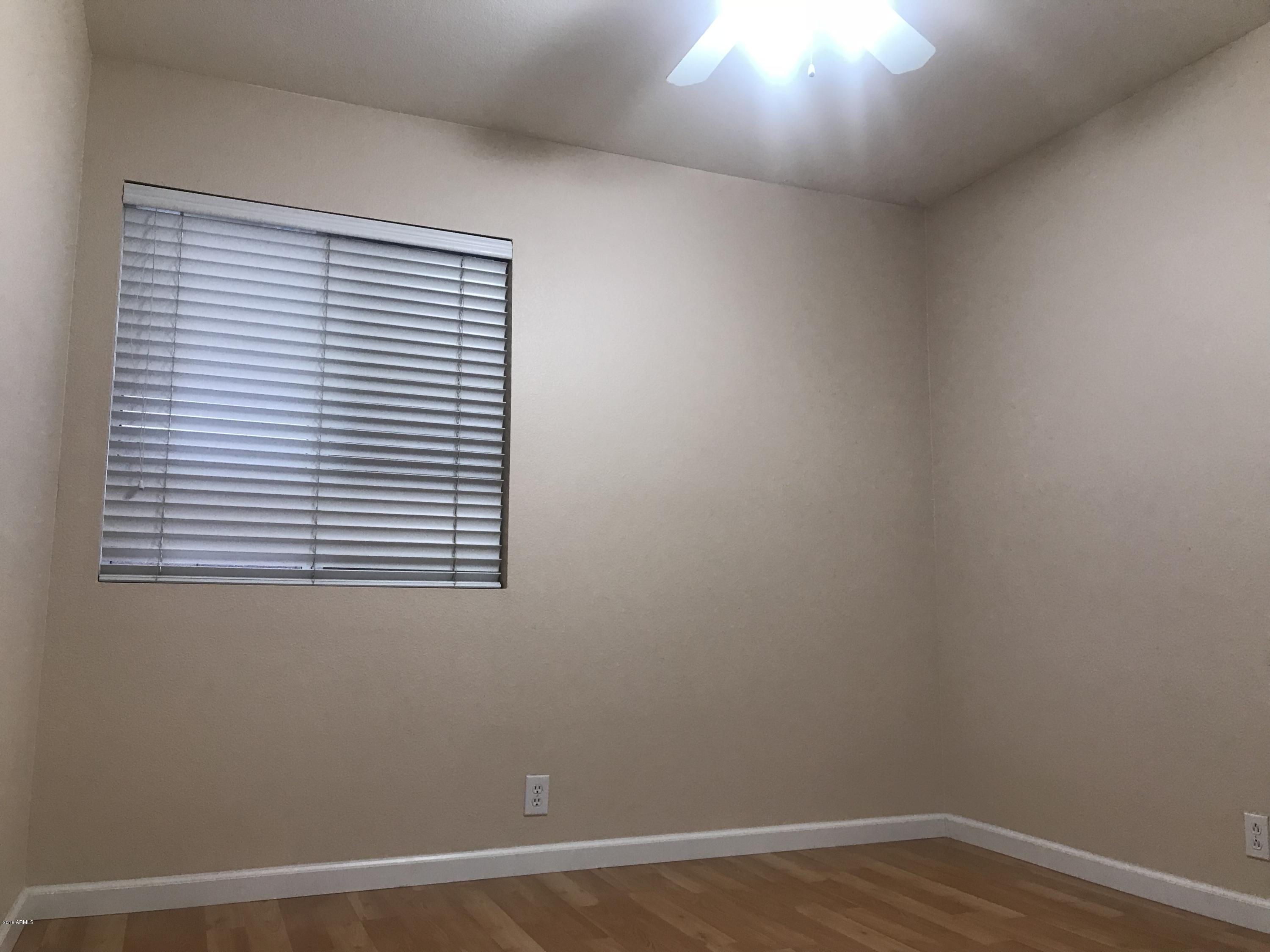 4133 West Bloomfield Road Phoenix, AZ 85029 - Photo 13 of 27 an empty room with a window