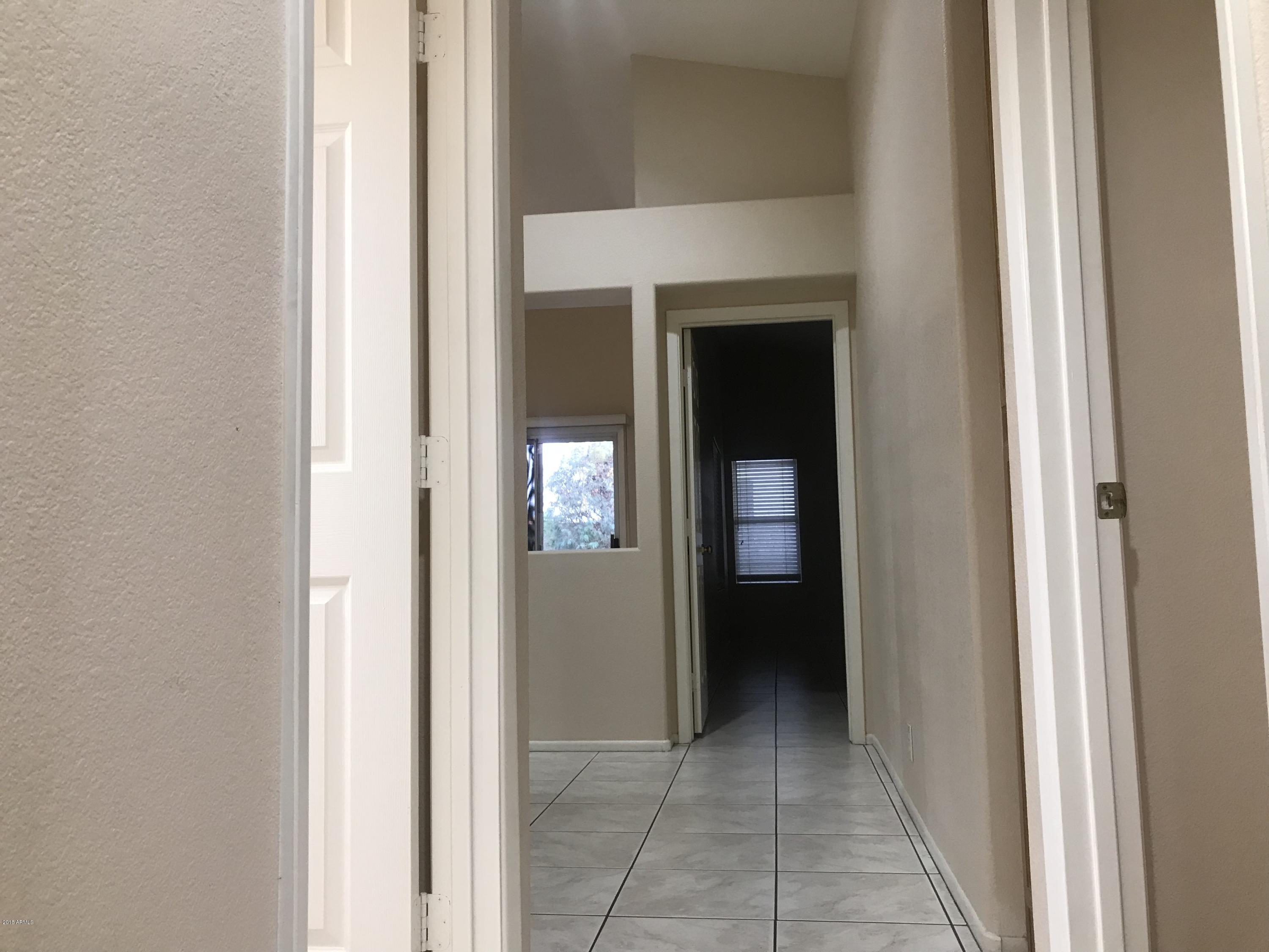 4133 West Bloomfield Road Phoenix, AZ 85029 - Photo 15 of 27 a view of a hallway with wooden shelves
