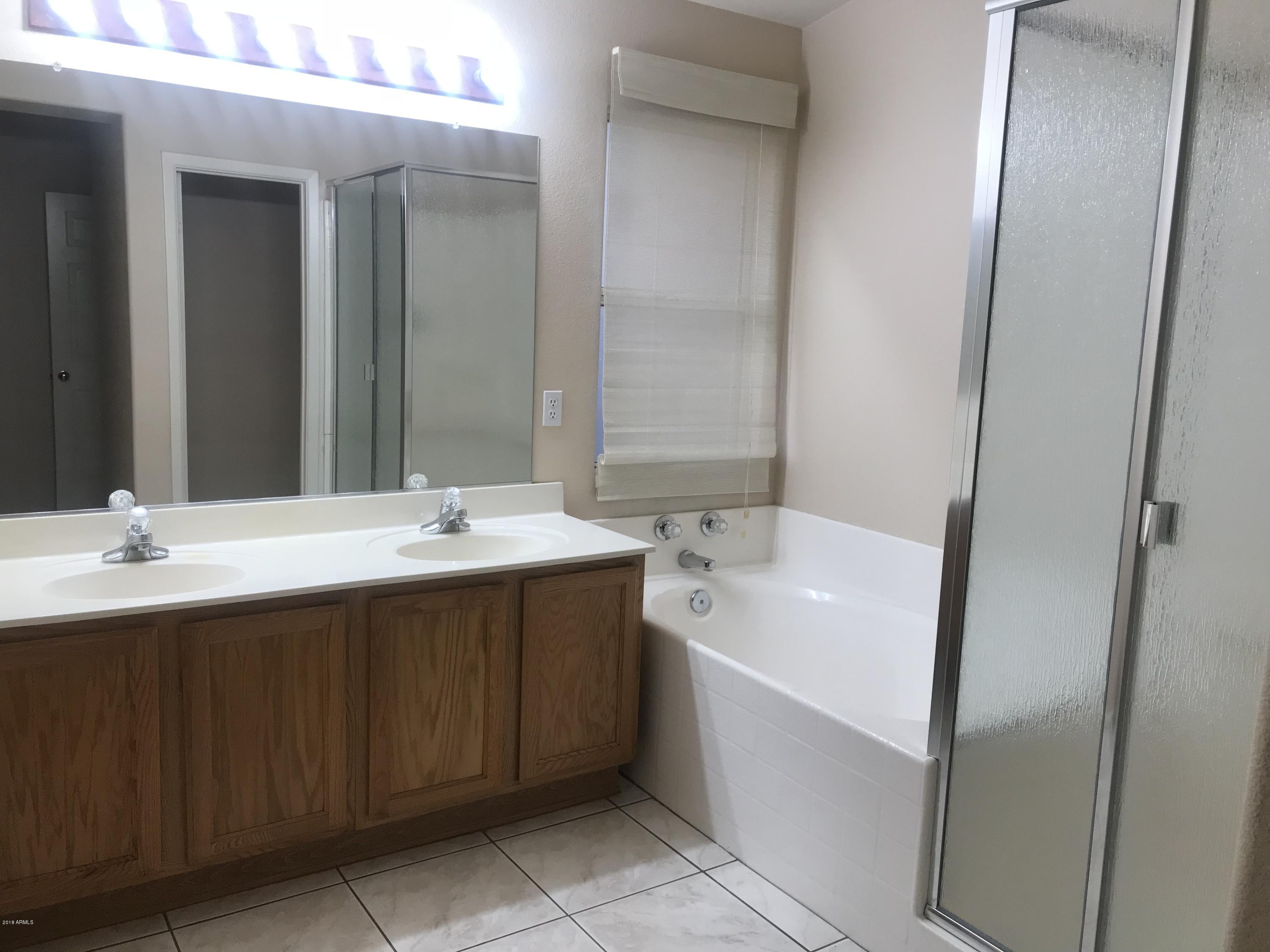 4133 West Bloomfield Road Phoenix, AZ 85029 - Photo 16 of 27 a bathroom with a sink and a mirror