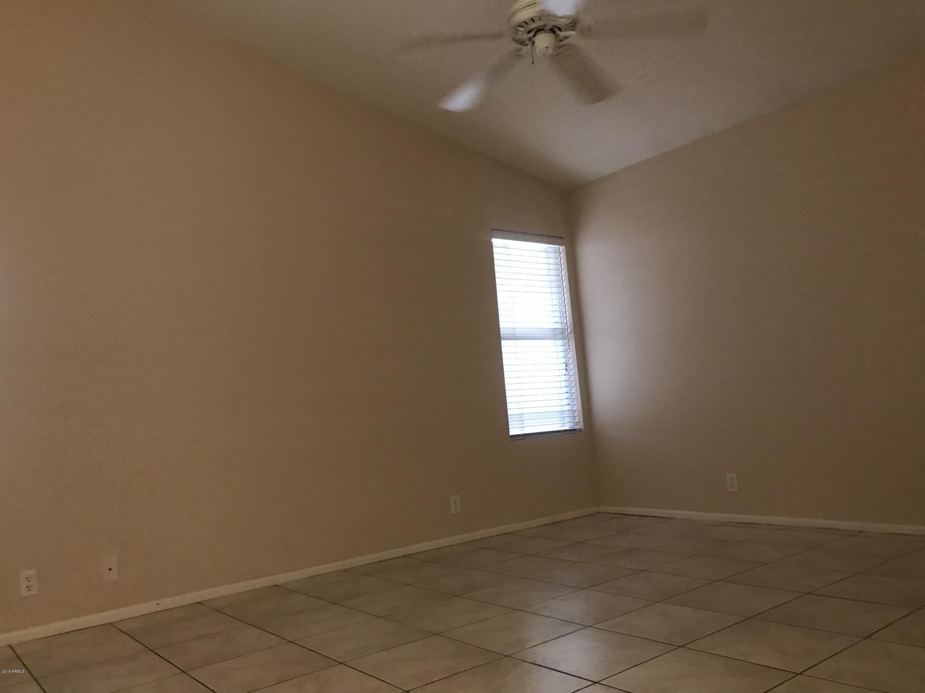 4133 West Bloomfield Road Phoenix, AZ 85029 - Photo 17 of 27 an empty room with a empty space and a window