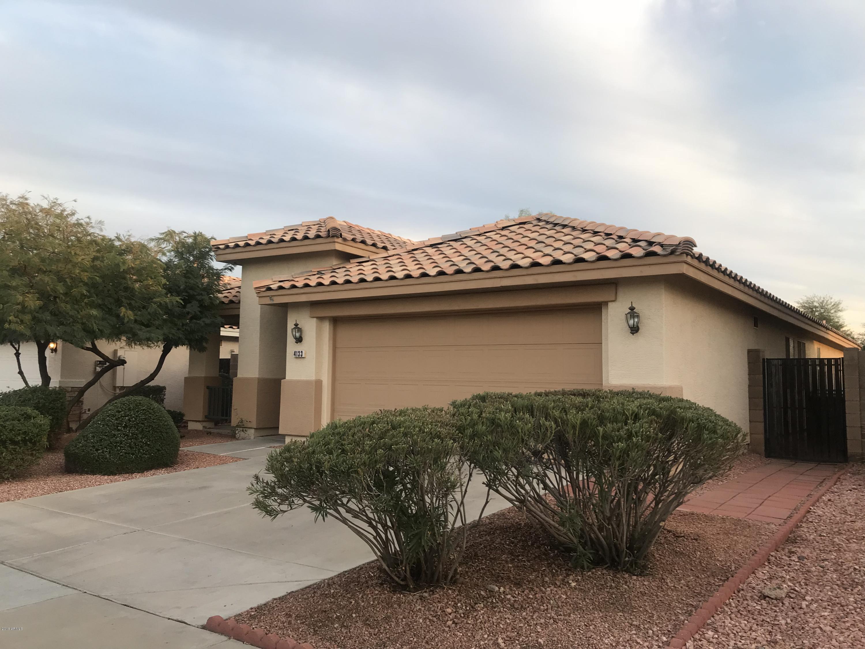 4133 West Bloomfield Road Phoenix, AZ 85029 - Photo 2 of 27 a view of a house with a garage and a yard