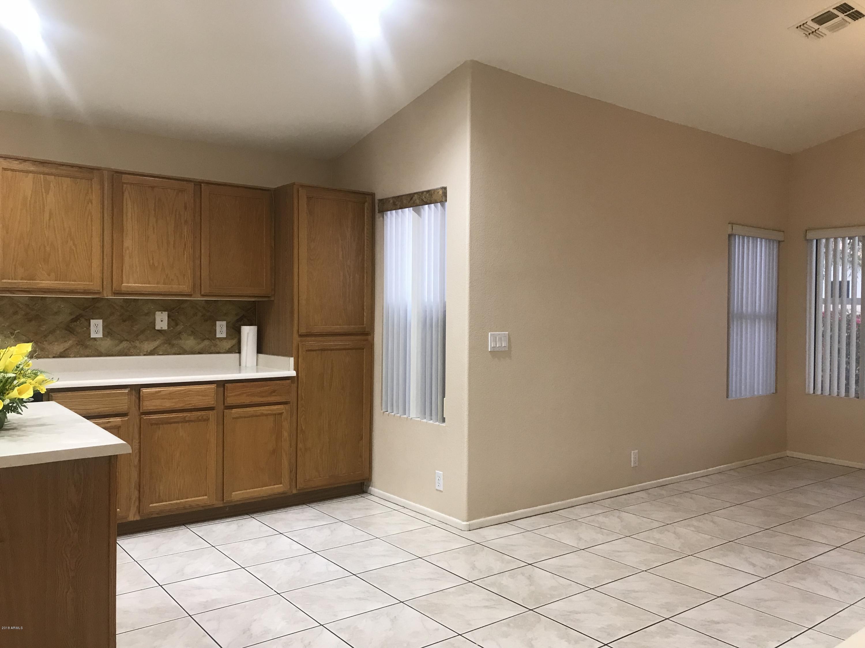 4133 West Bloomfield Road Phoenix, AZ 85029 - Photo 27 of 27 a kitchen with a sink and cabinets