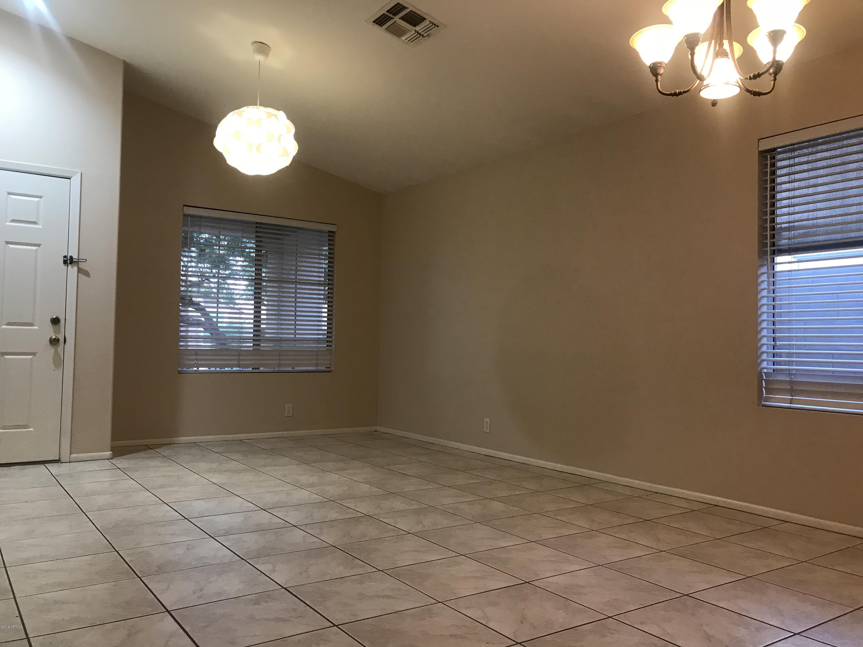 4133 West Bloomfield Road Phoenix, AZ 85029 - Photo 5 of 27 an empty room with windows
