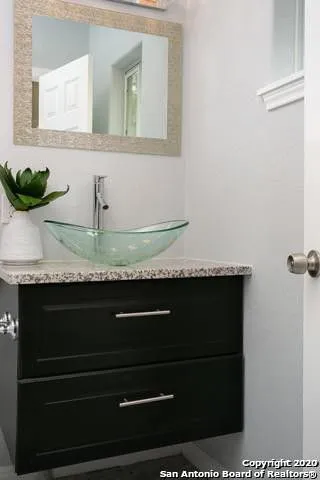 a bathroom with sink and mirror