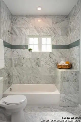 a bathroom with a bathtub and a toilet