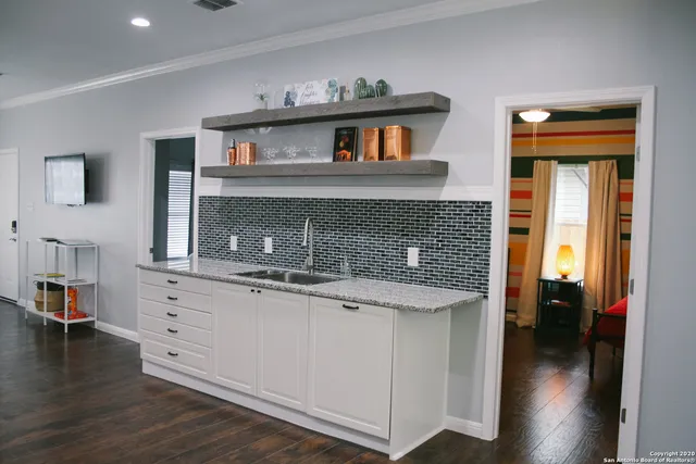 a view of kitchen with cabinets and wooden floor