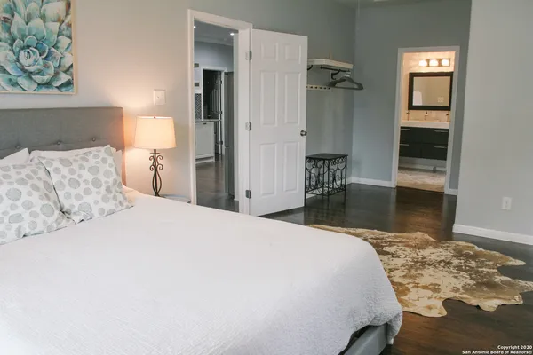 a bedroom with a bed and a table with closet