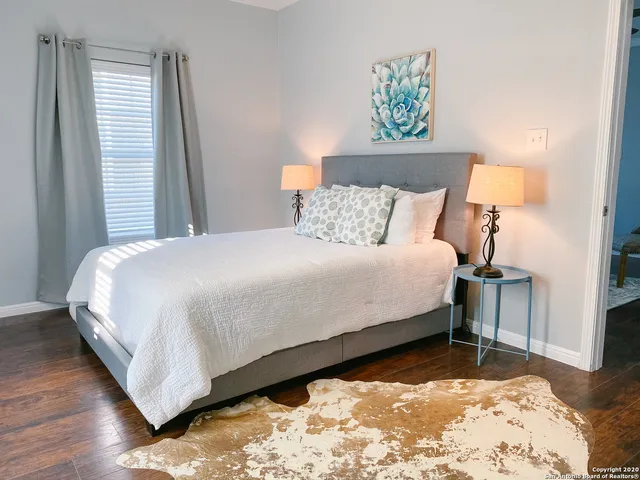 a bedroom with a bed and a painting on the wall