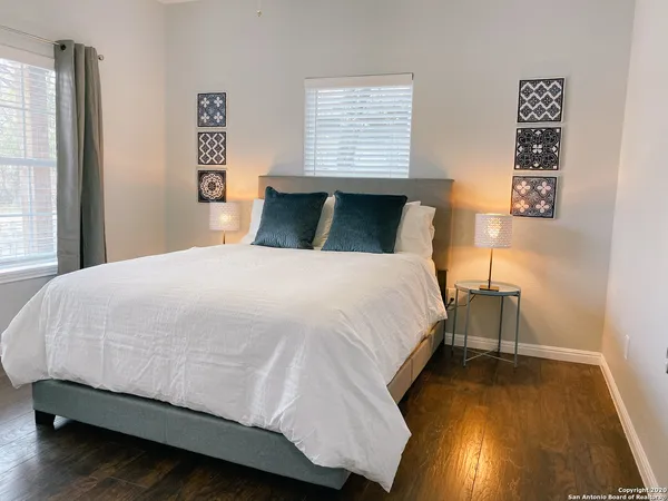 a bed sitting in a bedroom next to a window