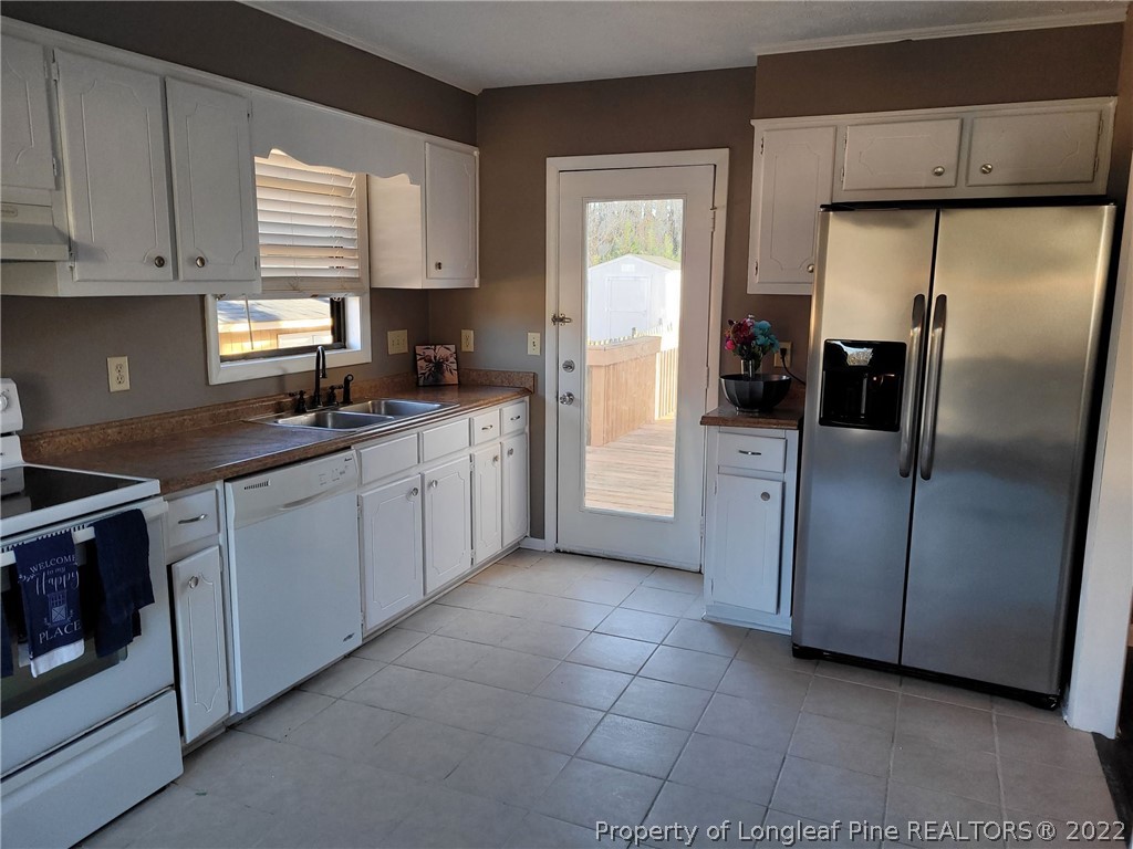 513 Andover Road Fayetteville, NC 28311 - Photo 11 of 21 a kitchen with stainless steel appliances granite countertop a refrigerator a sink a stove and dishwasher