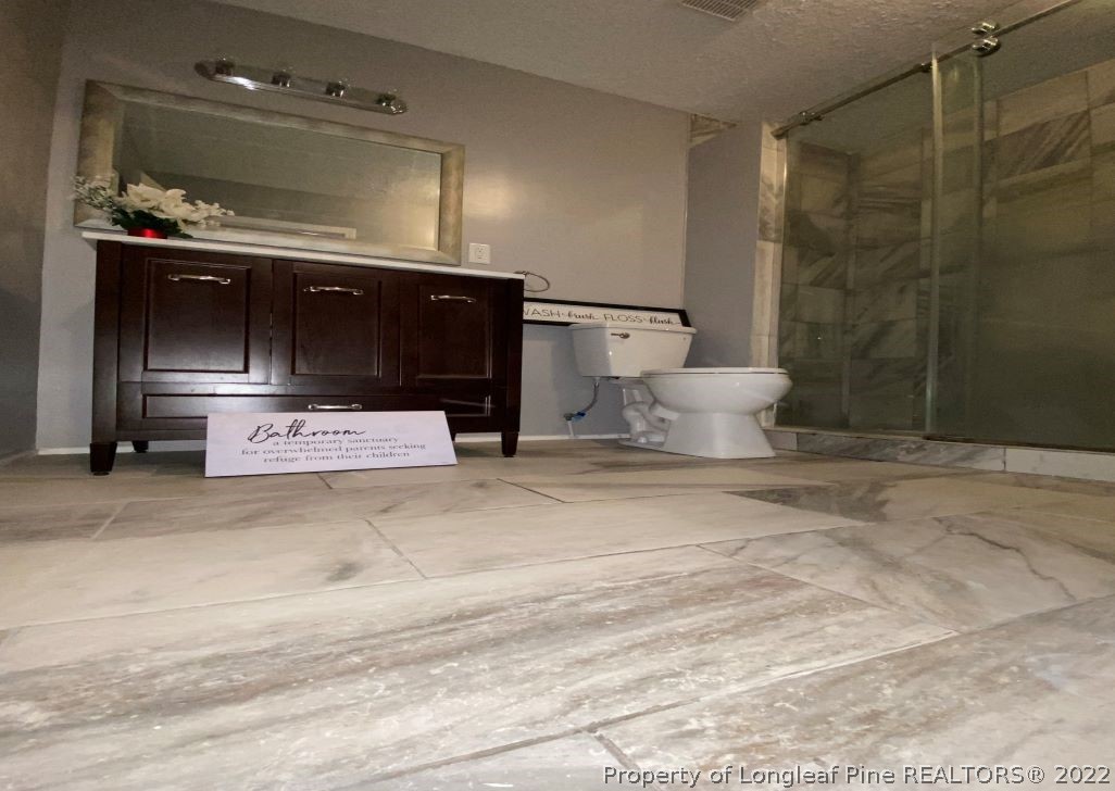 513 Andover Road Fayetteville, NC 28311 - Photo 14 of 21 a bathroom with a sink and a mirror
