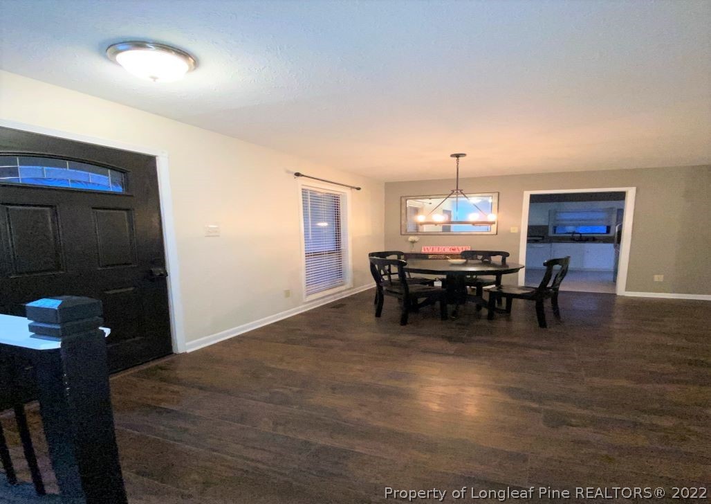 513 Andover Road Fayetteville, NC 28311 - Photo 20 of 21 a bed room with a bed and a chandelier