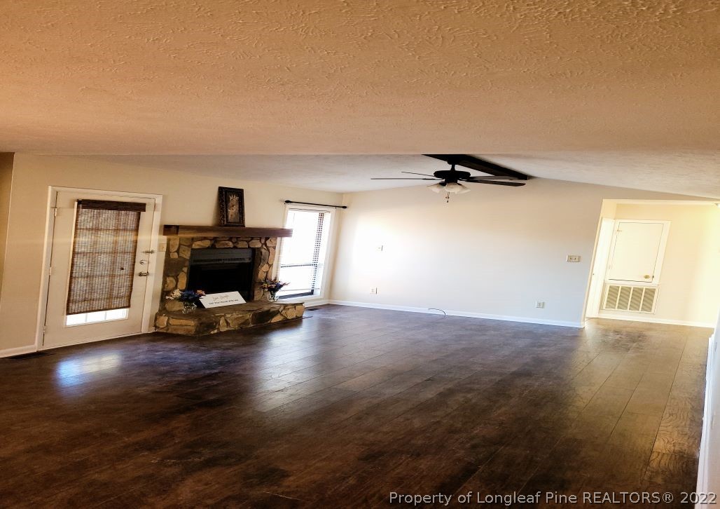 513 Andover Road Fayetteville, NC 28311 - Photo 5 of 21 a view of empty room with wooden floor and fireplace