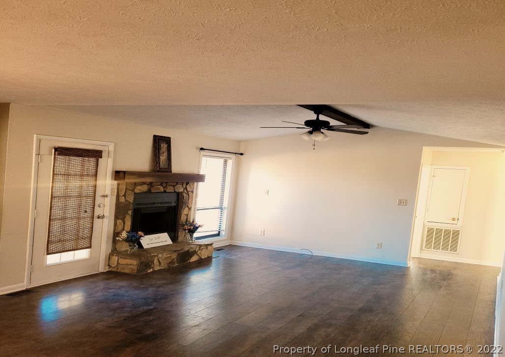 513 Andover Road Fayetteville, NC 28311 - Photo 6 of 21 a view of a livingroom with wooden floor a fireplace and window