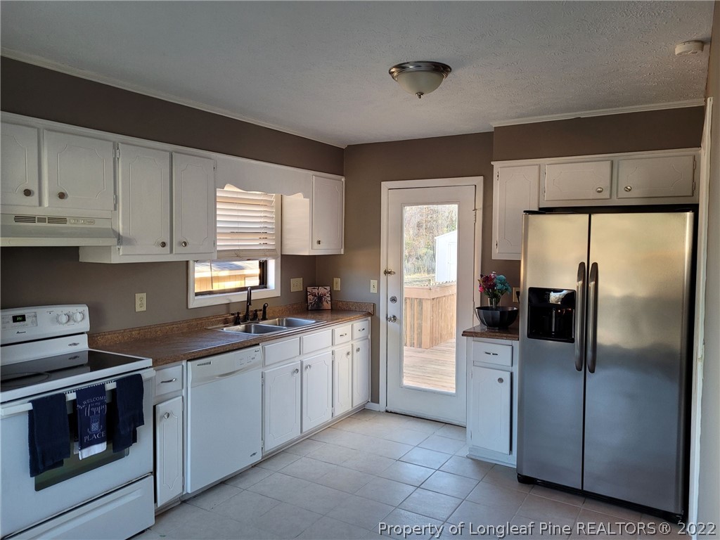 513 Andover Road Fayetteville, NC 28311 - Photo 8 of 21 a kitchen with stainless steel appliances granite countertop a refrigerator sink and stove