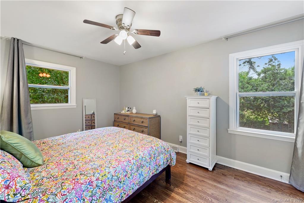 5600 Seacroft Road Charlotte, NC 28210 - Photo 12 of 18 a bedroom with a bed chandelier and a window