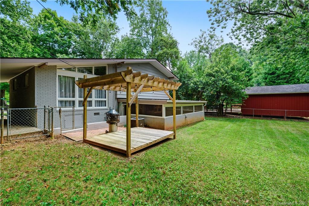 5600 Seacroft Road Charlotte, NC 28210 - Photo 17 of 18 a view of house with a big yard and large trees