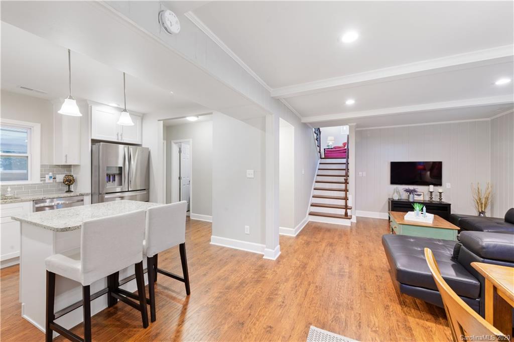 5600 Seacroft Road Charlotte, NC 28210 - Photo 6 of 18 a living room with furniture a flat screen tv and kitchen view