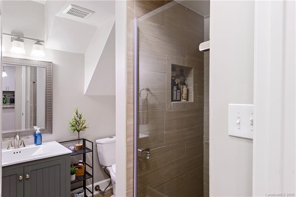5600 Seacroft Road Charlotte, NC 28210 - Photo 9 of 18 a bathroom with a sink a mirror and a shower
