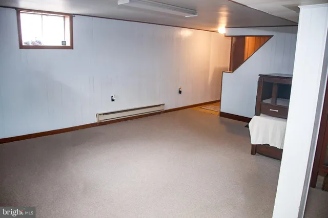 a view of a room with wooden floor and staircase
