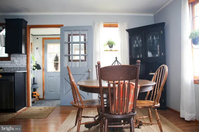 a view of a dining room with furniture window and wooden floor