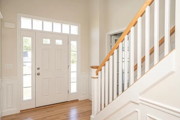 a view of an entryway with wooden floor and door
