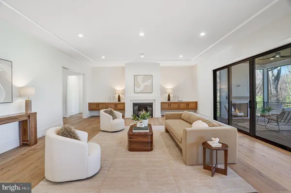 a dining hall with stainless steel appliances granite countertop a dining table chairs and chandelier