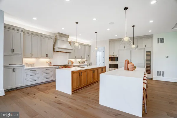 a kitchen with a stove sink and cabinets