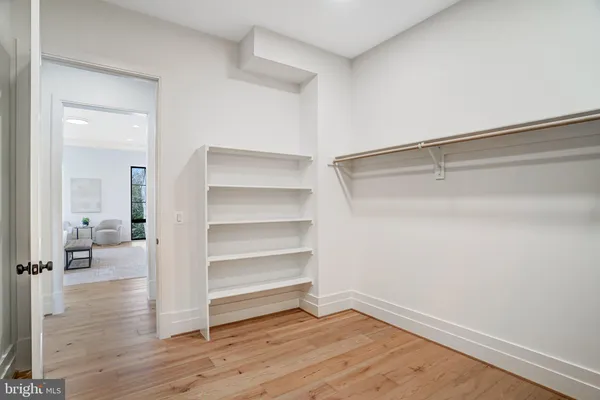 a bathroom with a sink a toilet a mirror a vanity and shower