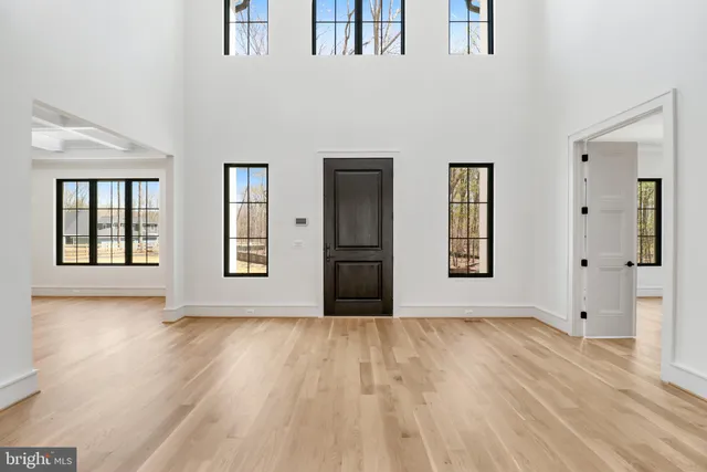 a view of an empty room with a fireplace and a window