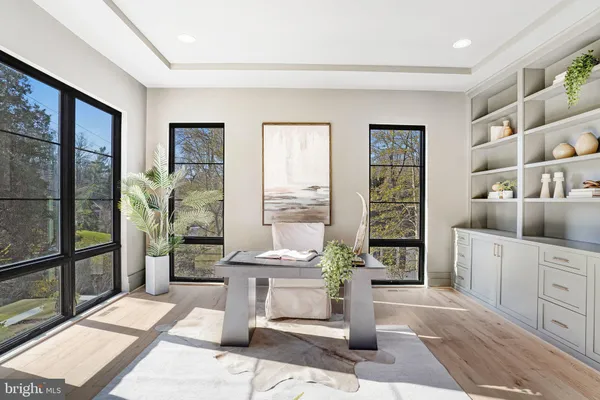 a view of a hallway with wooden floor and chandelier