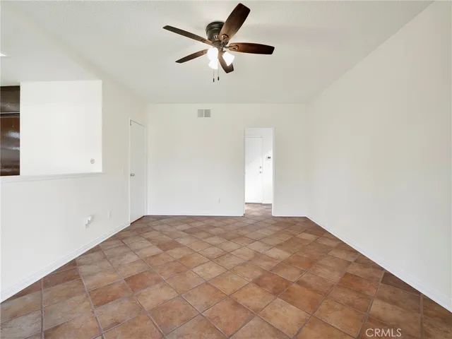 a view of a room with a ceiling fan and a rug