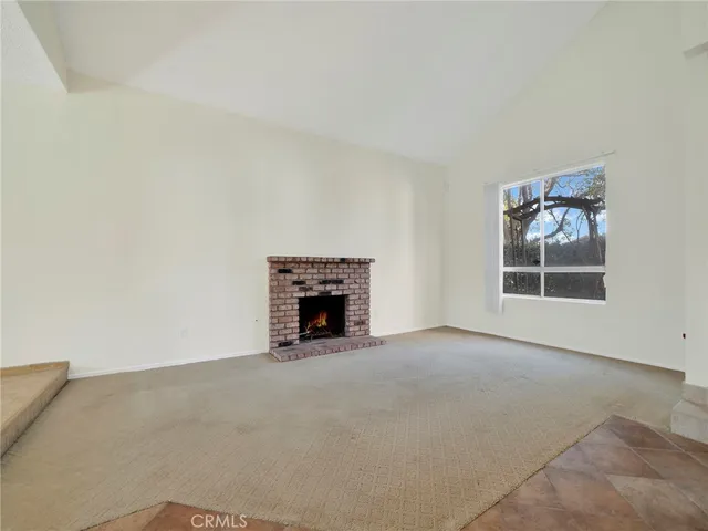 an empty room with a fireplace