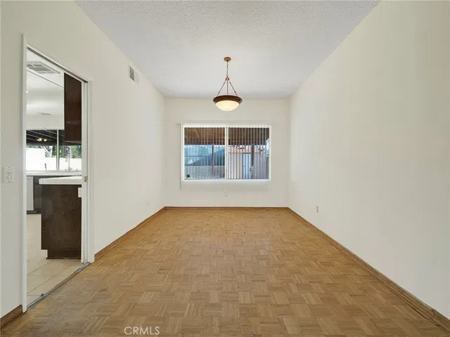 an empty room with windows and cabinet