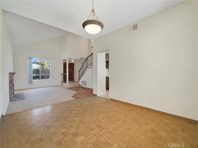 a view of a livingroom with wooden floor and a window