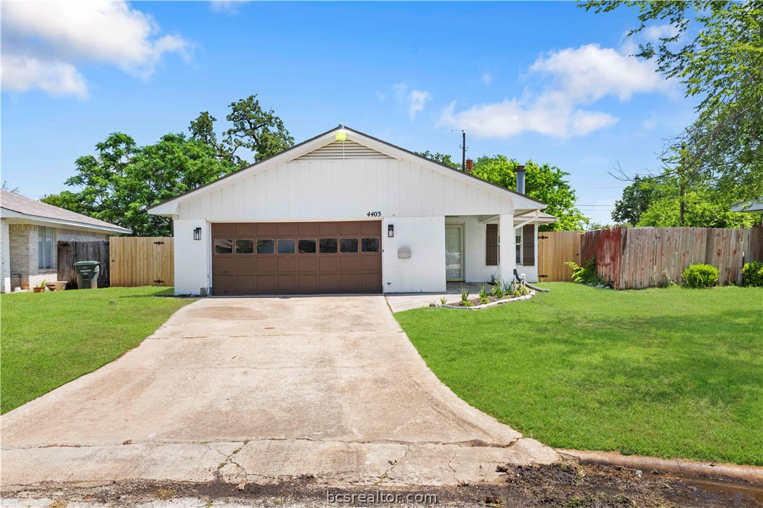 a front view of house with a garden