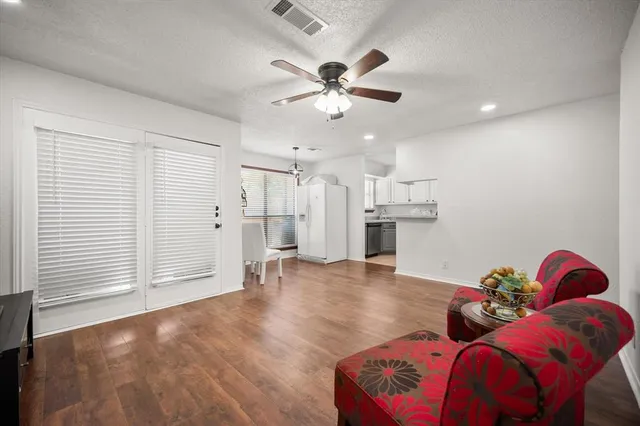 a living room with furniture and wooden floor