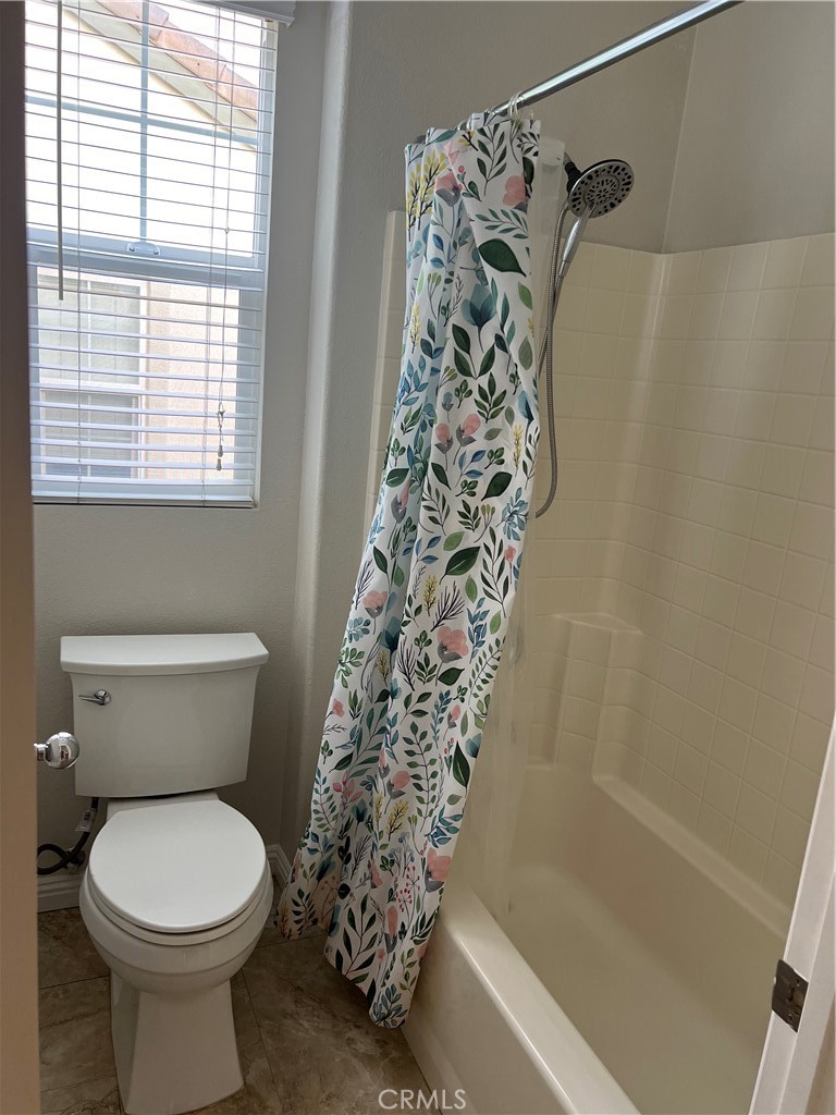 2243 Strickler Drive Fullerton, CA 92833 - Photo 15 of 20 a bathroom with a toilet and a shower curtain