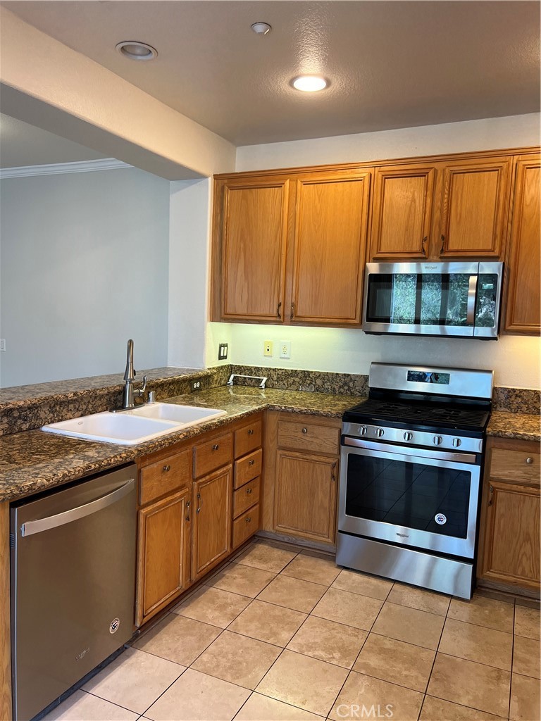 2243 Strickler Drive Fullerton, CA 92833 - Photo 10 of 20 a kitchen with stainless steel appliances granite countertop a stove sink and microwave